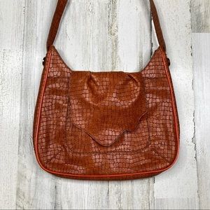 Korto Momolu orange embossed vegan leather purse